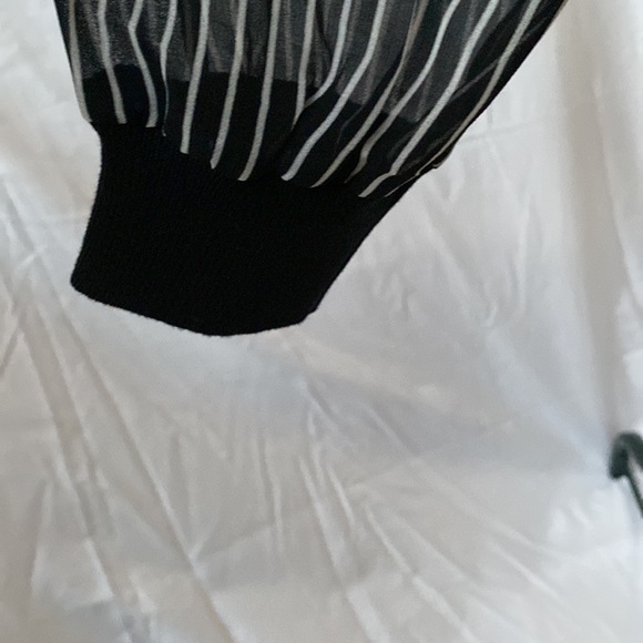Black sweater with black and white striped sleeves. Great condition. - Picture 4 of 7